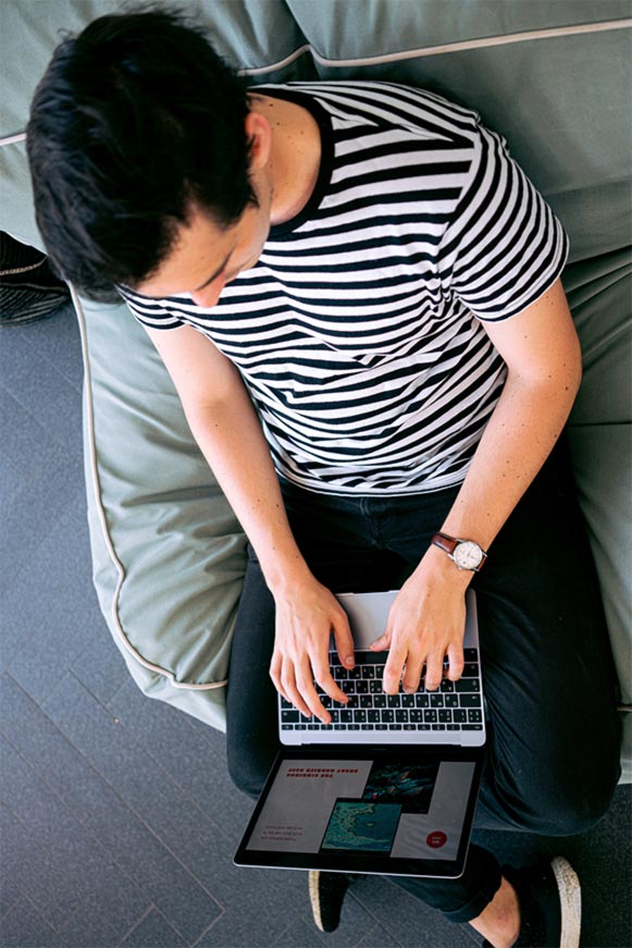 Monthly Strategy - striped shirt on laptop