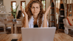 woman with hands up frustrated looking at laptop because reviews aren't showing up