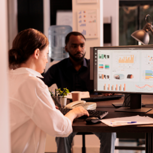 two people looking at analytics on a computer