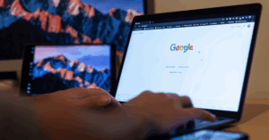 hands typing on a laptop with google search